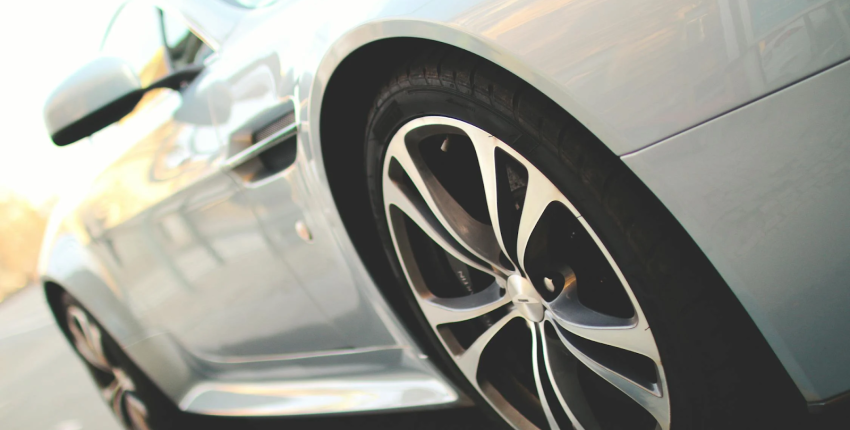 Close-up of a car's wheel and tire, showcasing the tread pattern and rim details for a blog feature image.