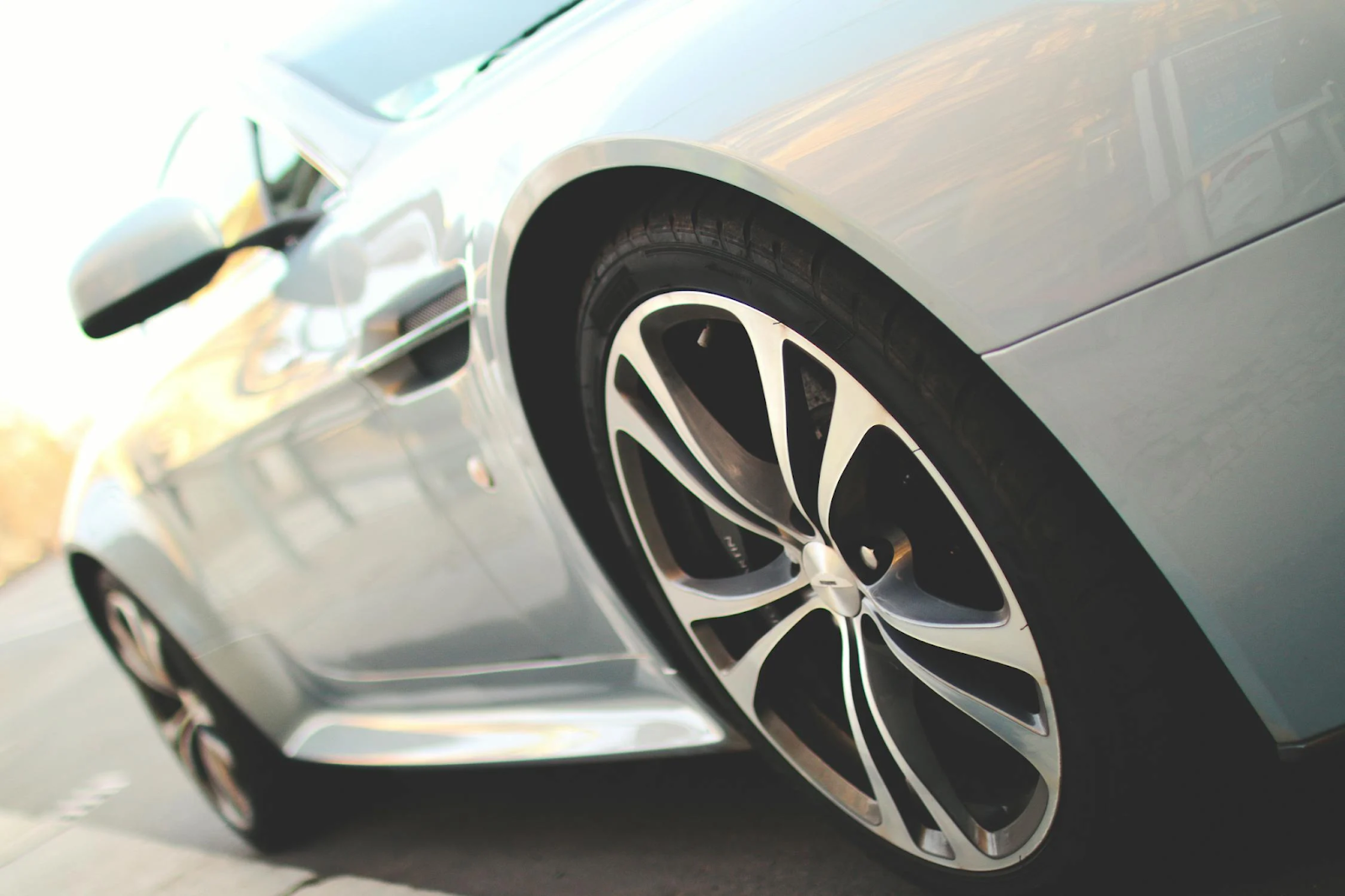 Close-up of a car's wheel and tire, showcasing the tread pattern and rim details for a blog feature image.